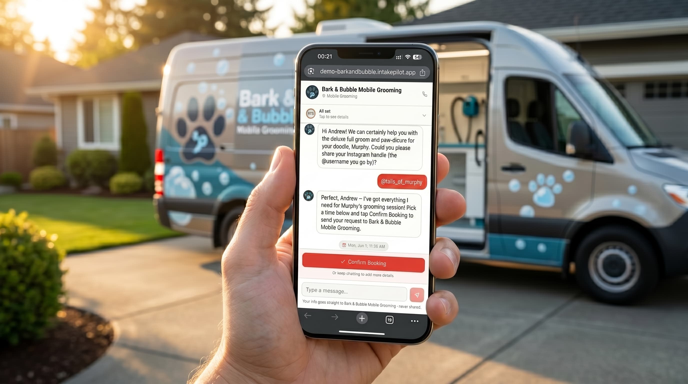 A mobile dog grooming van parked at a client’s home with a new booking request showing on a phone.